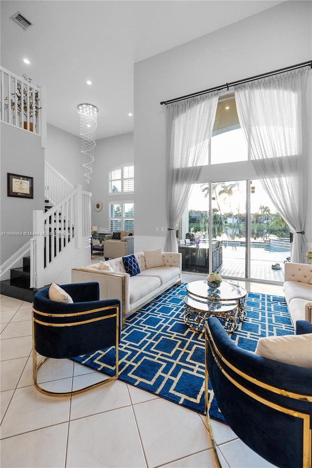 living room with tile patterned flooring and an inviting chandelier