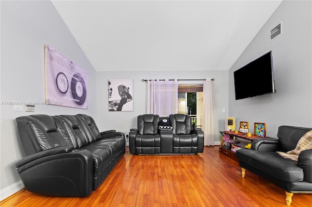 living room with wood-type flooring and vaulted ceiling