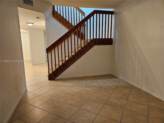 stairs with tile patterned flooring