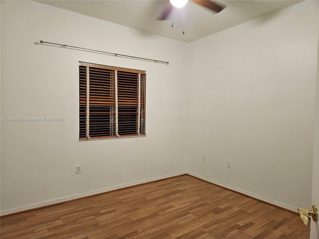 spare room featuring hardwood / wood-style flooring and ceiling fan