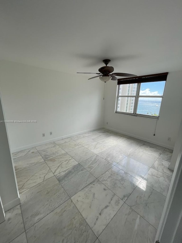 empty room with a water view and ceiling fan