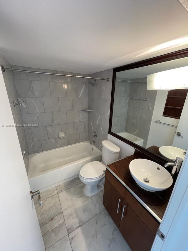 full bathroom featuring vanity, toilet, and tiled shower / bath