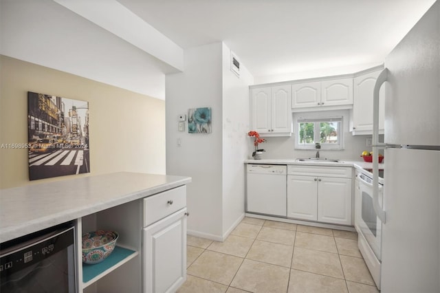 kitchen featuring white cabinetry, white appliances, sink, and light tile patterned floors