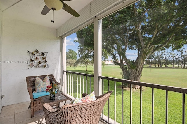 sunroom / solarium featuring ceiling fan