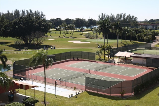 view of sport court with a lawn