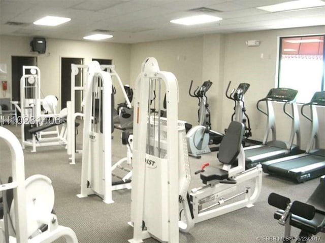 workout area featuring a drop ceiling