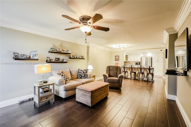 living room with ceiling fan, crown molding, and dark wood-type flooring