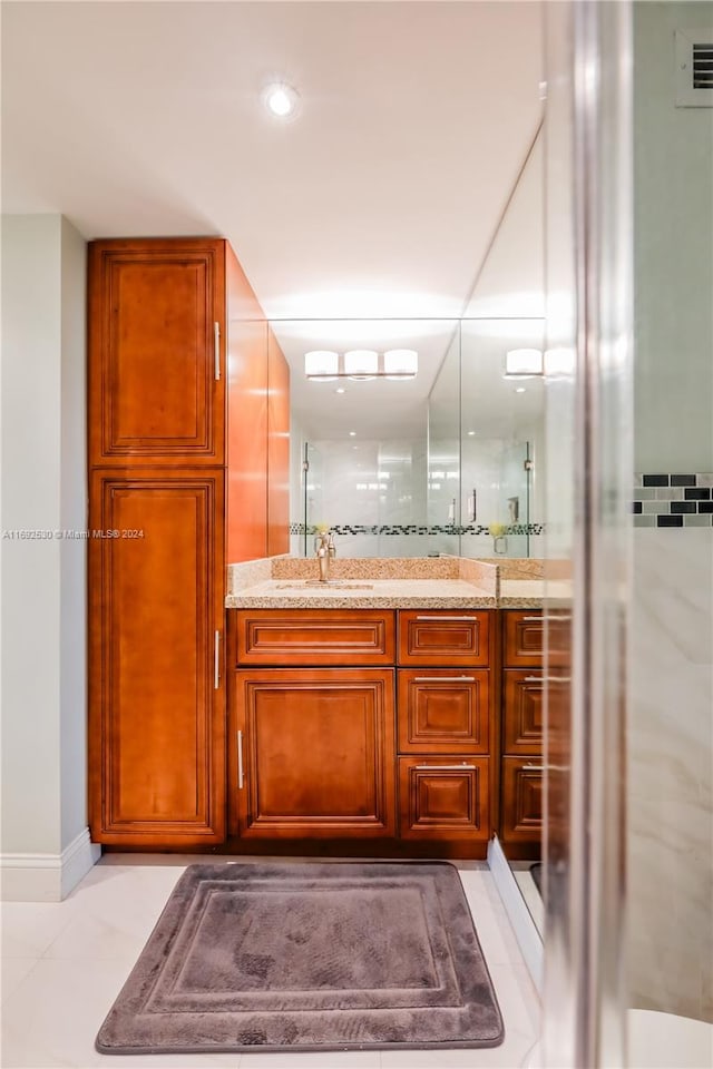 bathroom with vanity, tile patterned floors, and walk in shower