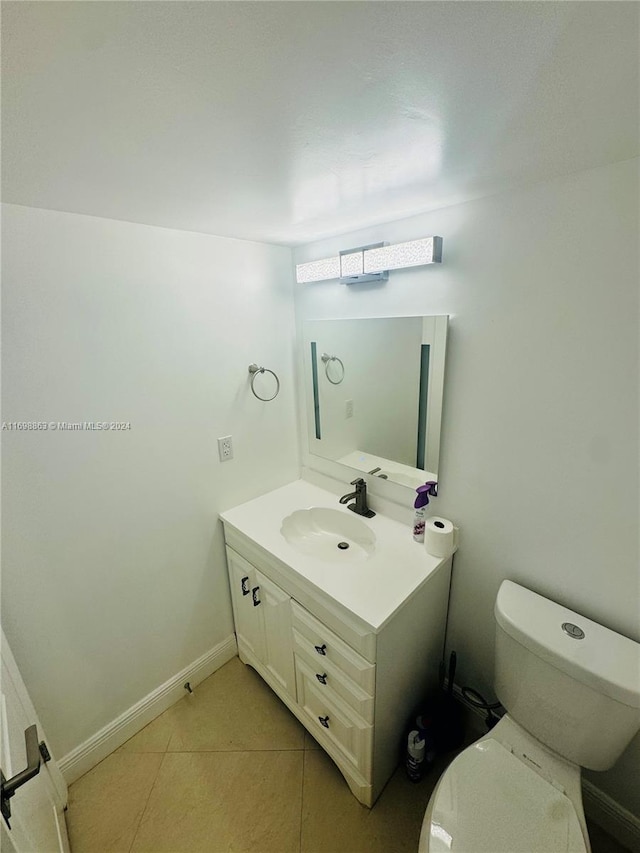 bathroom featuring tile patterned floors, vanity, and toilet