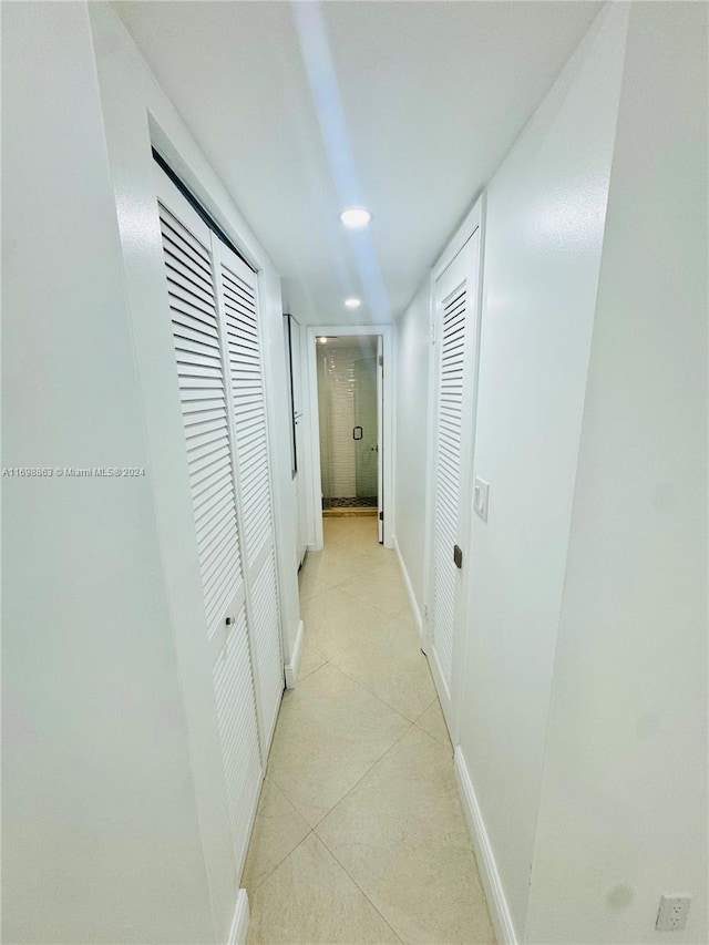 hallway with light tile patterned flooring