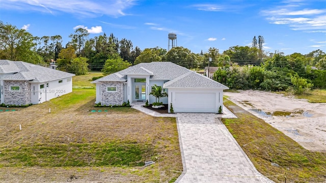 view of front facade with a garage and a front lawn