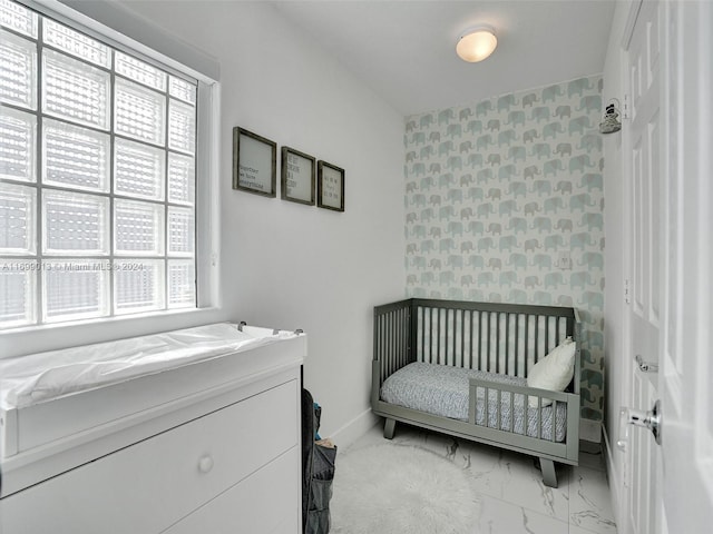 bedroom with a crib and multiple windows