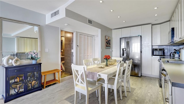 dining area with light wood-type flooring