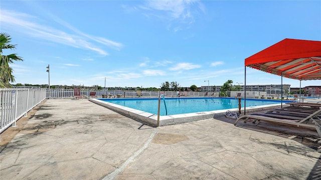 view of swimming pool with a patio