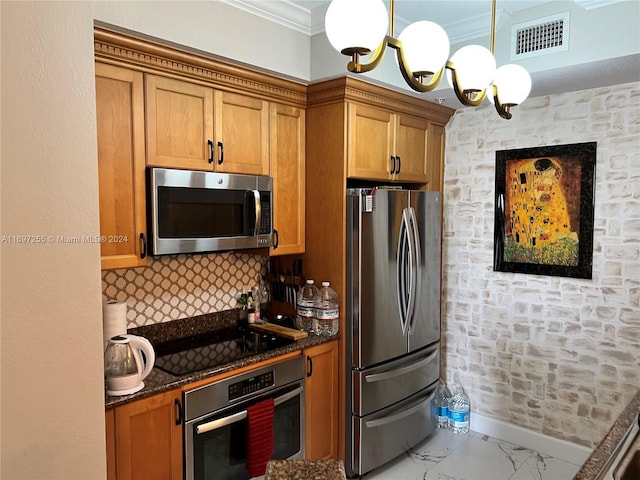 kitchen featuring appliances with stainless steel finishes, backsplash, crown molding, decorative light fixtures, and dark stone countertops