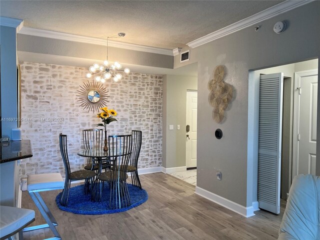 1660 Renaissance Commons Blvd Unit 2518, Boynton Beach, FL 33426 - dining space featuring crown molding, a chandelier, wood finished floors, and a textured ceiling