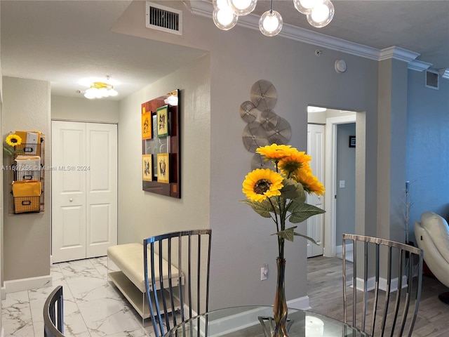 corridor with hardwood / wood-style flooring and ornamental molding