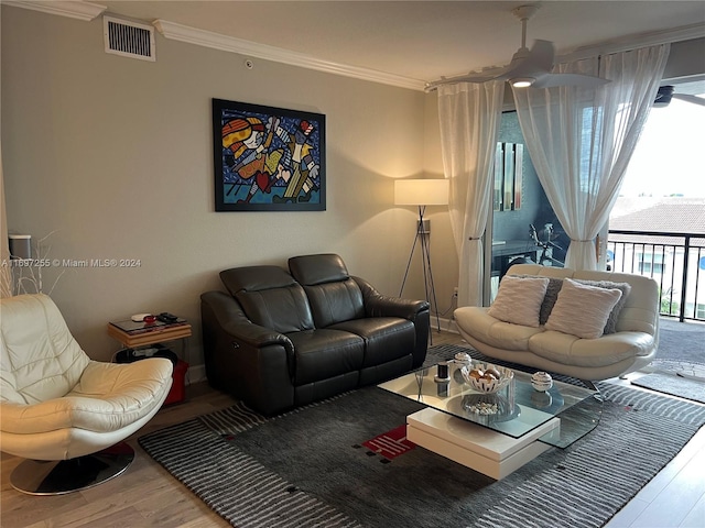 living room with hardwood / wood-style floors and crown molding