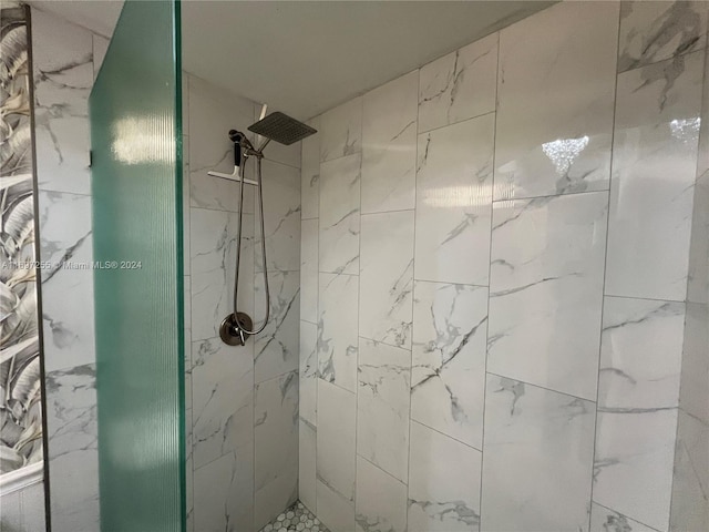 bathroom with a tile shower