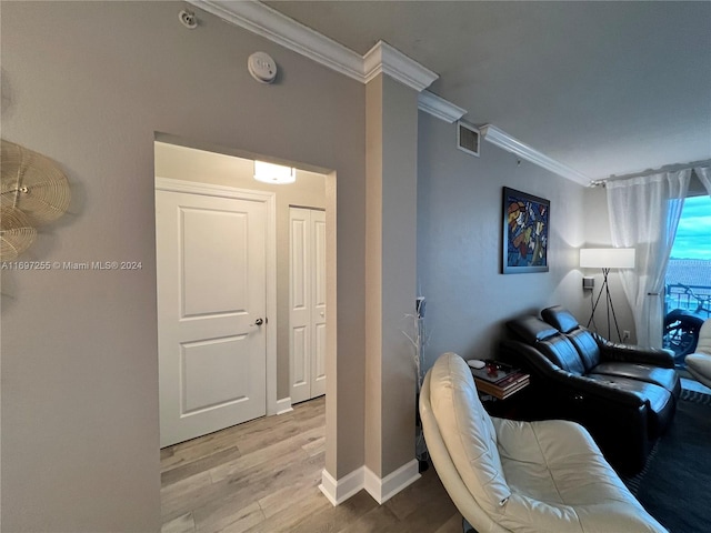 living room featuring light hardwood / wood-style flooring and ornamental molding