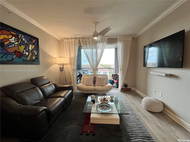 living room featuring hardwood / wood-style flooring, ceiling fan, and crown molding