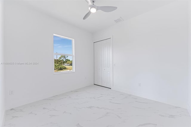 unfurnished room with ceiling fan