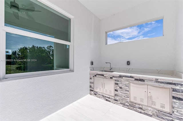 bathroom featuring ceiling fan and sink