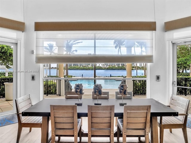 dining room with a water view and hardwood / wood-style floors