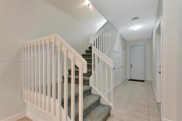 staircase featuring tile patterned floors