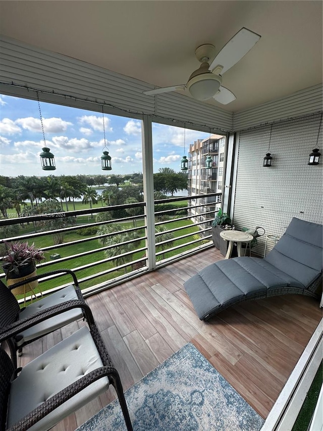 sunroom / solarium featuring ceiling fan