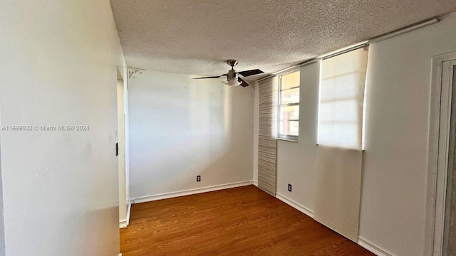 empty room featuring ceiling fan, hardwood / wood-style floors, and a textured ceiling