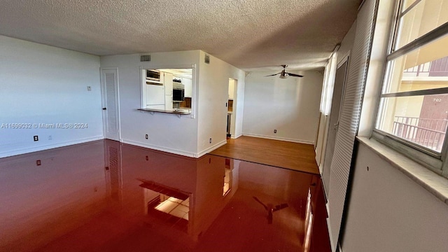 unfurnished room featuring ceiling fan, a textured ceiling, and hardwood / wood-style flooring