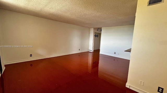 unfurnished room featuring a textured ceiling