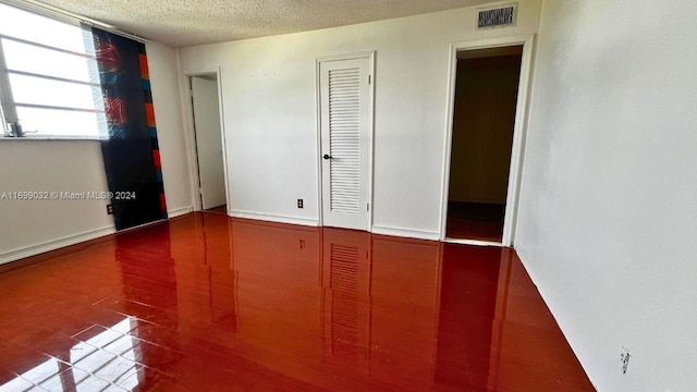 unfurnished bedroom with tile patterned floors and a textured ceiling