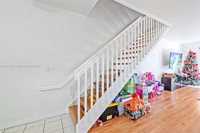 staircase with hardwood / wood-style floors