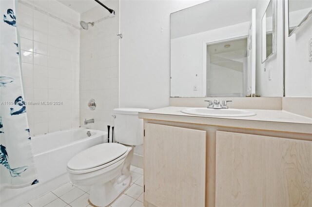 full bathroom with shower / bathtub combination with curtain, tile patterned flooring, vanity, and toilet