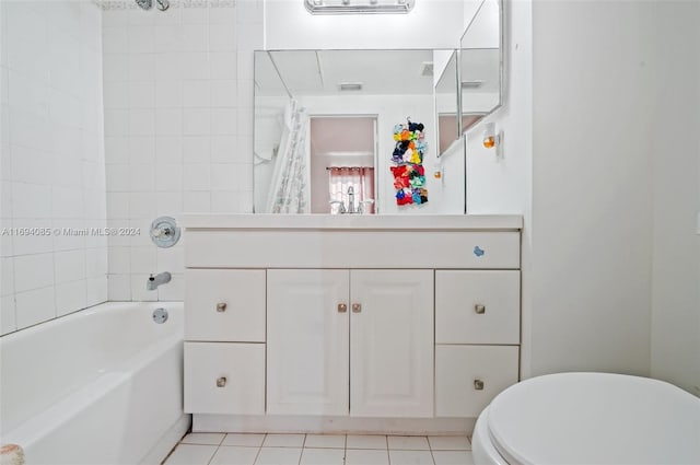 full bathroom featuring tile patterned floors, vanity, toilet, and tiled shower / bath