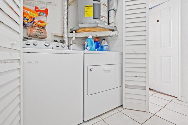 laundry area featuring washing machine and dryer and light tile patterned floors