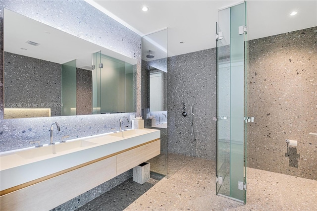 bathroom featuring vanity, tile walls, and walk in shower