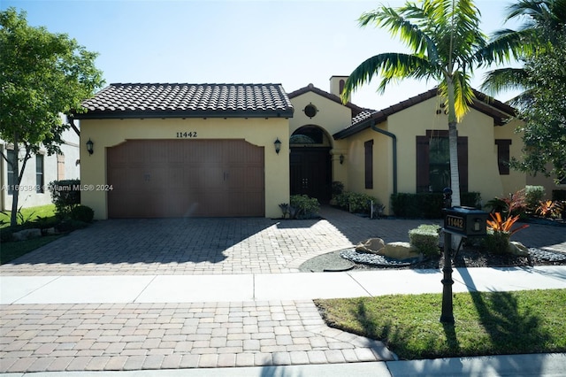 mediterranean / spanish home featuring a garage