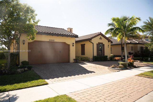 mediterranean / spanish home featuring a garage