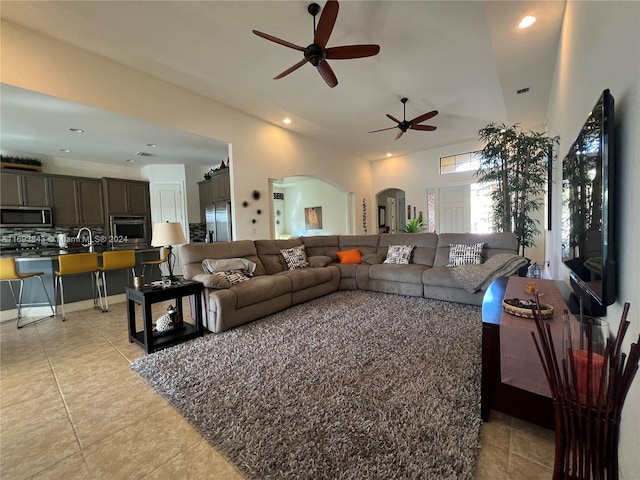 living room featuring ceiling fan and light tile patterned flooring