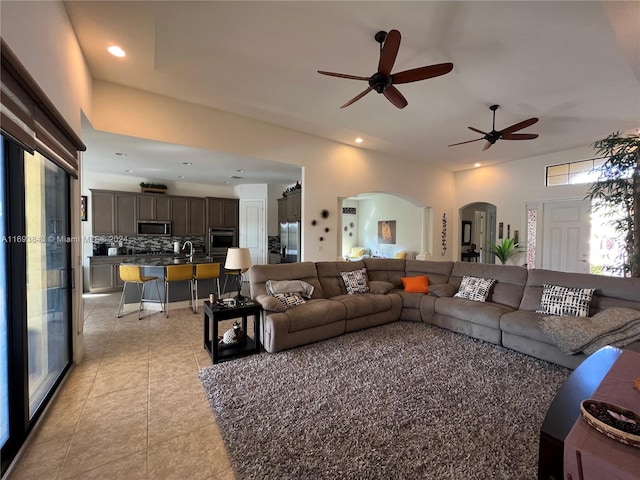 living room with ceiling fan and light tile patterned floors