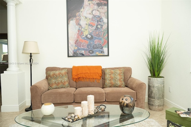 living room with light tile patterned floors and decorative columns