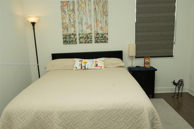 bedroom with dark wood-type flooring