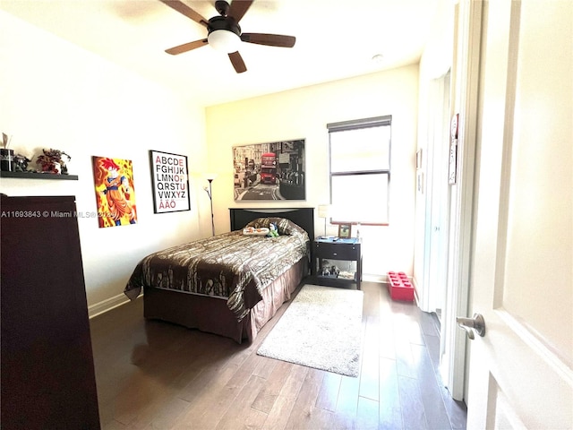 bedroom featuring hardwood / wood-style floors and ceiling fan