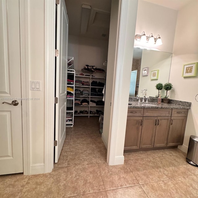 bathroom featuring tile patterned flooring and vanity