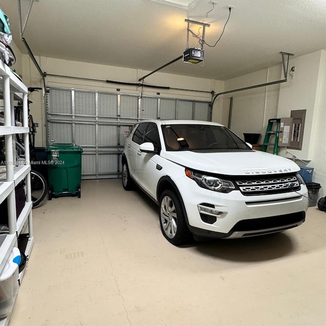 garage featuring electric panel and a garage door opener