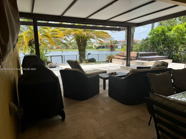 view of patio / terrace with a grill, a water view, and an outdoor hangout area