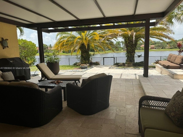 view of patio / terrace with outdoor lounge area, area for grilling, and a water view